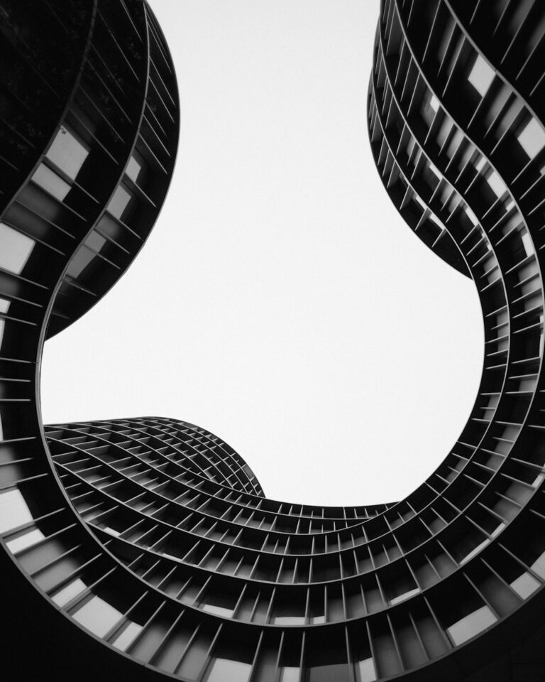 The curved facade of Axel Towers in Copenhagen against a bright sky